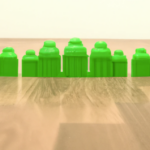 “toy green buildings lined up by size on a wood floor, wide angled photo ” Profile George × DALL·E Human & AI